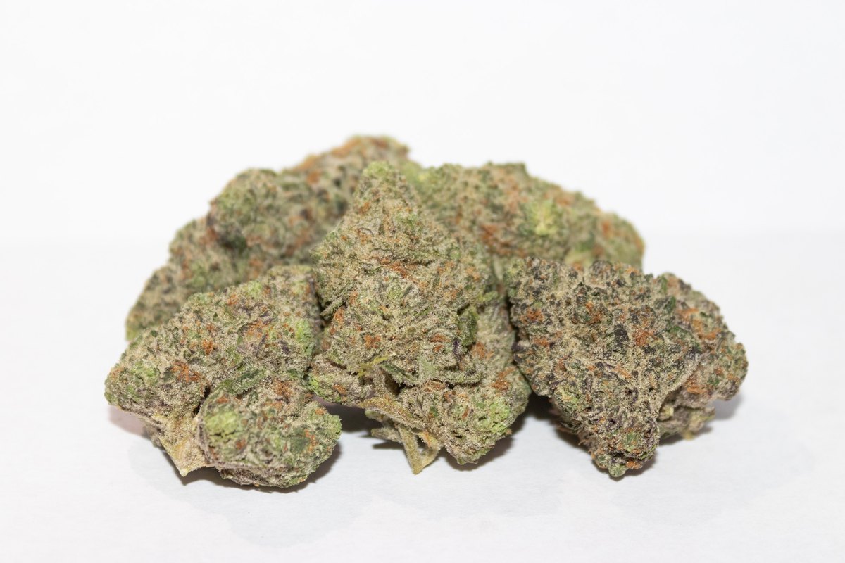White Runtz strain by Highway Dispos: heavily frosted hybrid bud on hessian linen with cedar barn light.