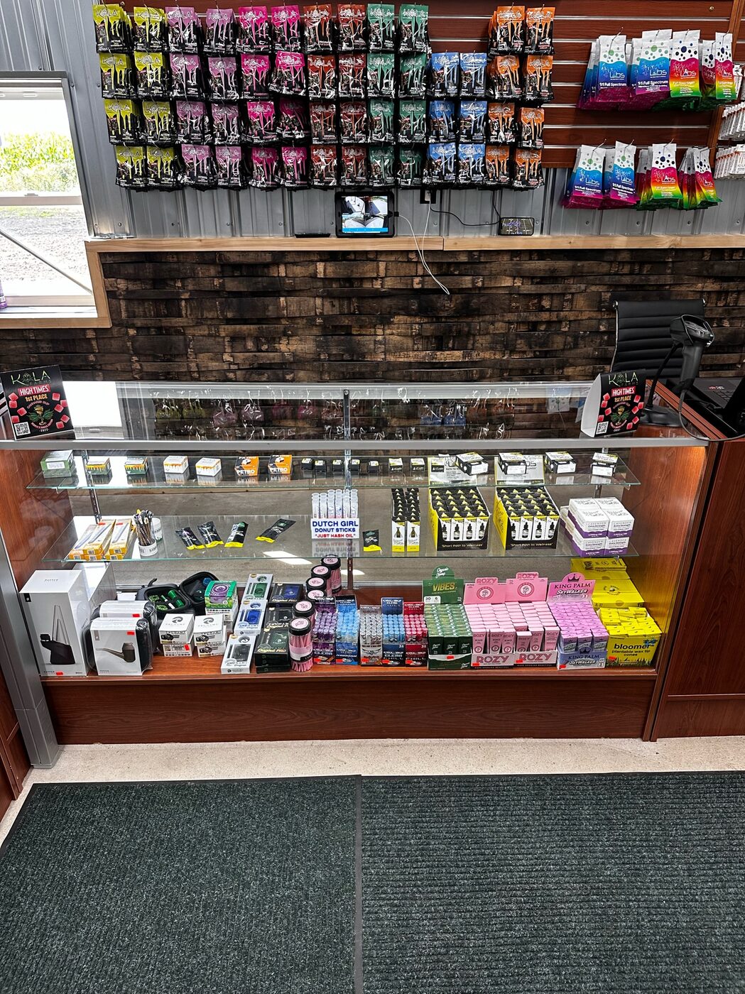 Glass display case of vape products inside the Highway Dispos store.
